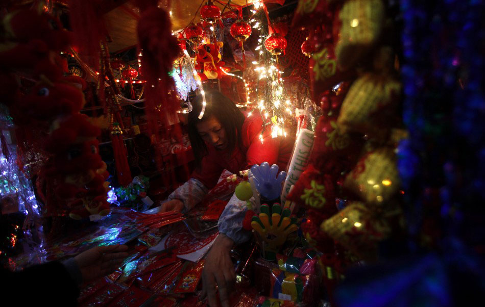 217615 a vendor stands inside her shop selling chinese new year products at a      