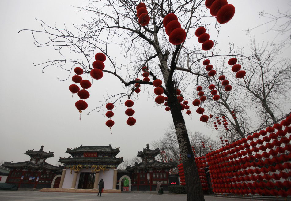 217616 a woman walks past red lantern decorations for the upcoming temple fai      