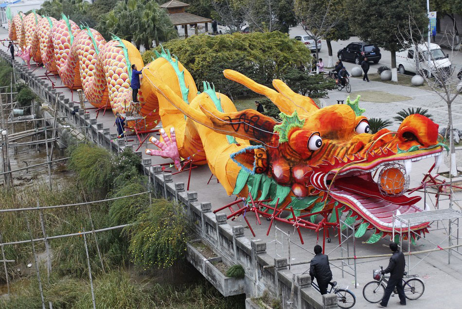 217625 workers decorate a dragon shaped sculpture ahead of the chinese new ye      